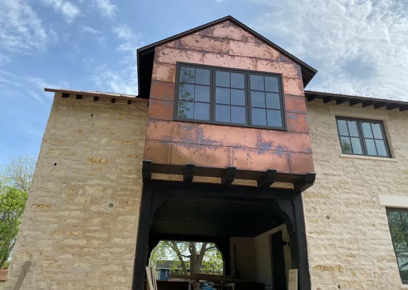 Copper metal panel facade on a stone building for Metal Roof Coating in Branson